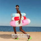 Woman on a beach with colorful inflatable rings and a bottle, with text overlay.