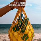 Yellow net bag with beach bottles held by a hand on a beach, with text overlay.