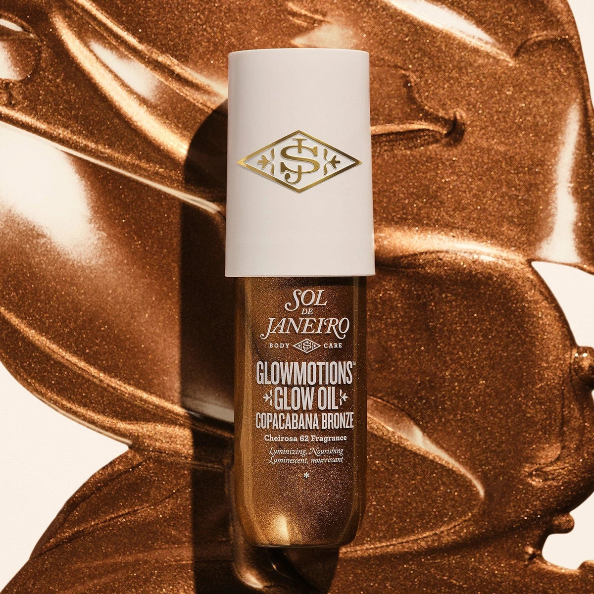 Image of the sol de janeiro glowmotions glow body oil in shade copacabana bronze spread out and you can really see how glowy bronze it is 