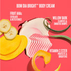 BOM DIA BRIGHT Body Cream smear with banana slices, yellow citrus peel, and green willow bark peel on a bright pink background with product benefits text.